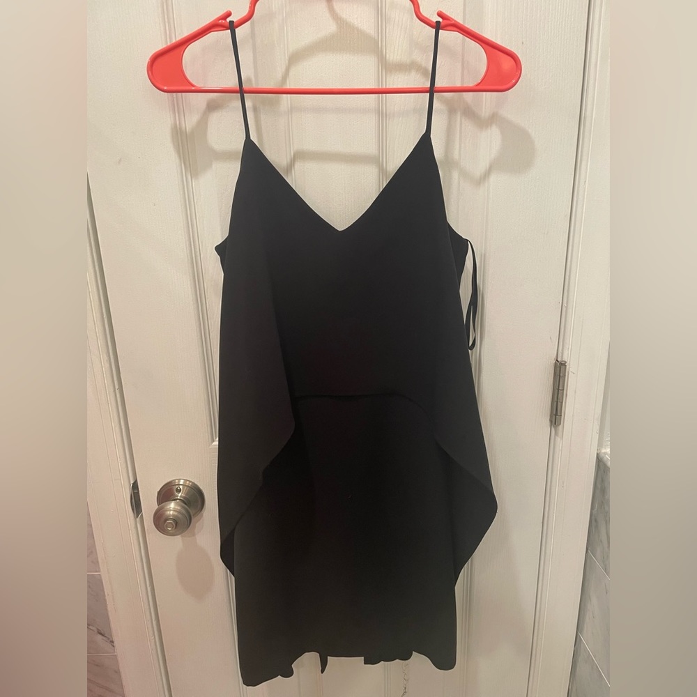 Size 0 little black dress. Has a fun flowy, cape like top. Is very flattering.